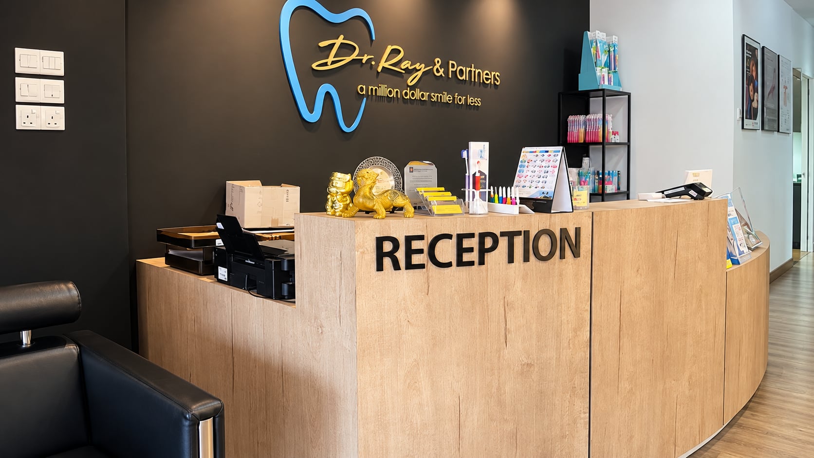 Reception desk with the Dr Ray & Partners logo